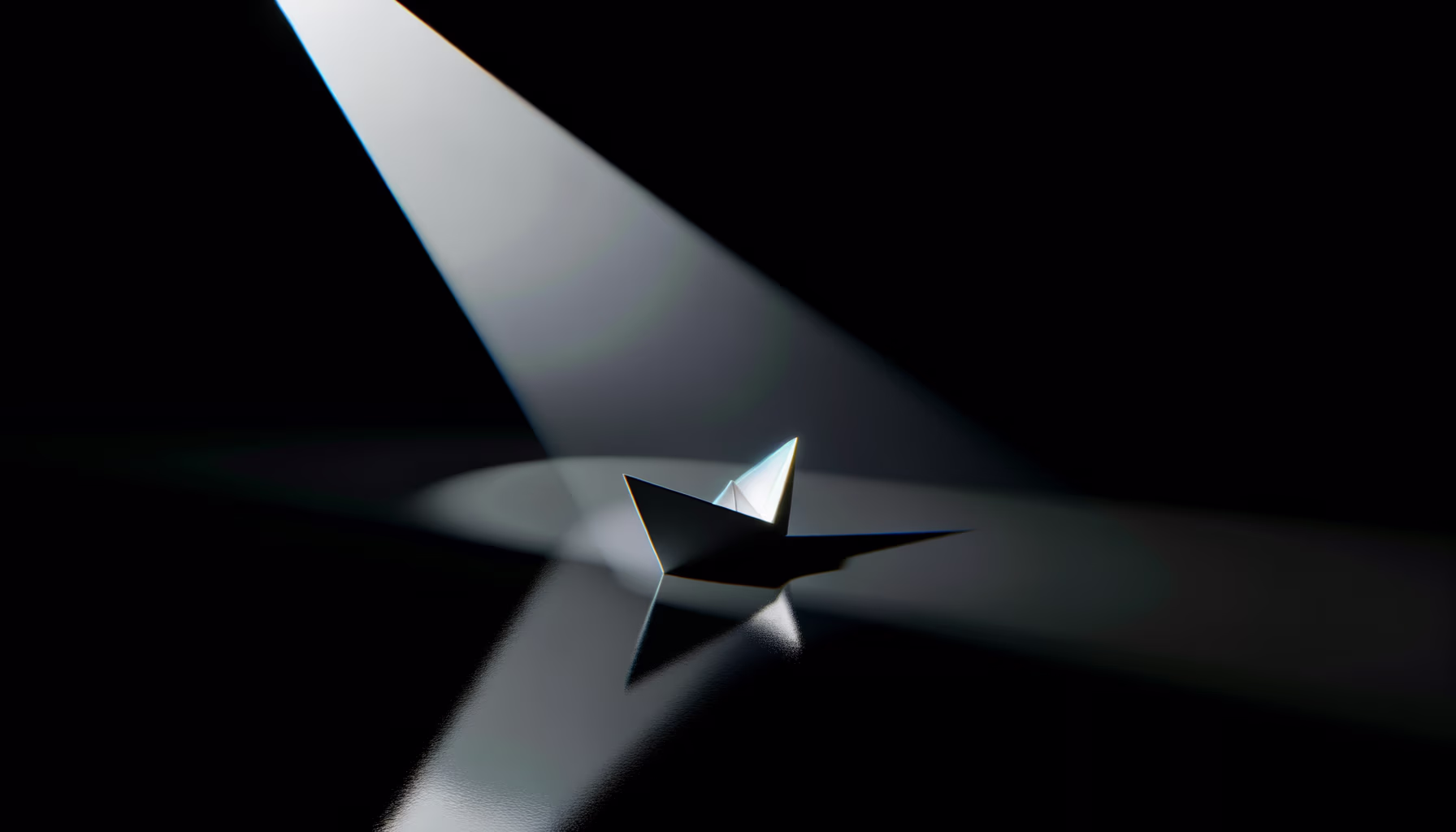 Ein schlichtes Papierboot in einem intensiven Lichtkegel auf dunklem, spiegelndem Grund.